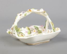 A Rockingham porcelain encrusted miniature basket. Puce Griffin mark to base, circa 1830-1842.