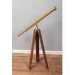 A brass 19th century style telescope on brass mounted tripod.