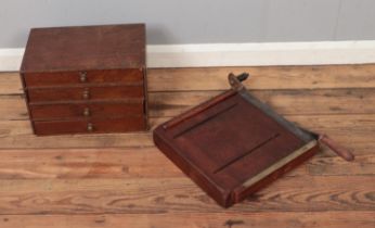 A small set of four drawers along with a vintage guillotine.