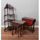 A corner whatnot with four graduated shelves including nest of tables with burr walnut tops and