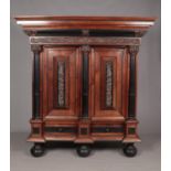 A rosewood and ebonised Schrank with applied carved decoration in the Baroque style. Having two