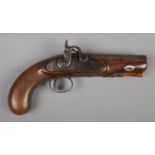 A 19th century percussion cap pistol. Having walnut grip and damascus 11.5cm octagonal barrel.
