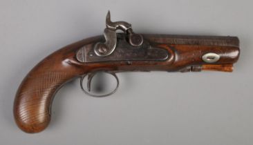 A 19th century percussion cap pistol. Having walnut grip and damascus 11.5cm octagonal barrel.