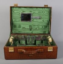 A crocodile skin dressing case by JW Robinson & Co, Los Angeles, with fitted interior and contents