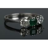An Art Deco platinum, diamond and emerald ring. Size M. 2.57g. Total diamond approximately 0.5ct.
