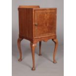 An Edwardian walnut bedside cabinet raised on four cabriole supports. Height 80cm, Width 42cm, Depth