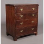 A Georgian oak chest of four drawers raised on ogee bracket feet and having later brass handles.