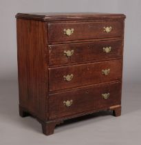 A Georgian oak chest of four drawers raised on ogee bracket feet and having later brass handles.