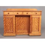 A Victorian satin birch desk. Having two drawers over three cupboard doors. Height 81cm, Width