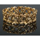 A 9ct gold textured bracelet of floral design, by Cropp & Farr. 35.39g.