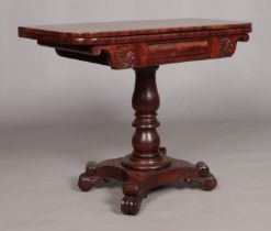 A Victorian carved mahogany fold over card table. Height 72cm, Top open 91cm x 91cm.