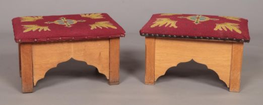 A small pair of oak prayer stools with embroided seats. Height 30cm, Width 48cm, Depth 32cm.