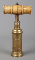A Thomason type patent brass corkscrew with turned bone handle. Bearing coat of arms inscribed Ne