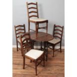 An oak drop leaf dining table with barley twist gateleg support along with four ladder back dining