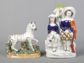 A 19th century Staffordshire figure of a Zebra, along with Staffordshire spill vase modelled as a