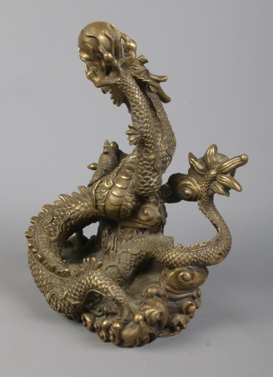 A cast bronze sculpture of a Chinese dragon holding a flaming pearl. Height 18cm. - Image 3 of 5