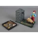 A novelty cast iron money bank, Artillery Bank, along with a small quantity of world coins.