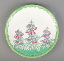 Charlotte Rhead for Crown Ducal, a ceramic charger decorated with Foxgloves, pattern number 4953.