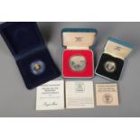 Three cased Royal Mint coins. Includes United Kingdom Silver Proof One Pound Coin, Piedfort Silver