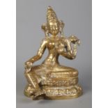 A Sino Tibetan cast gilt metal figure of a seated deity. Height 17.5cm.