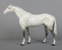 A large Beswick horse in dapple grey, model 1564. Height 28cm. Good condition.