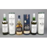 Three cased and sealed bottles of whisky, to include two Laphroaig Islay Single Malt Scotch