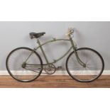 A WW2 era Paratrooper folding push bike with green painted tubular frame with central folding