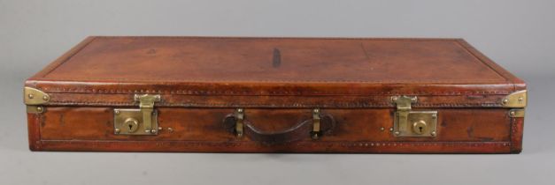 An early 20th century French Moynat leather and metal bound flat travel trunk. Height 13cm, Width