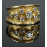 An 18ct gold and nine stone diamond ring. Total diamond weight approximately 1.2ct. Size R 1/2. 10.