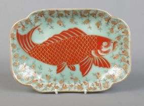 A Japanese quatrefoil shaped dish decorated with a carp on celadon background. Bearing marks in