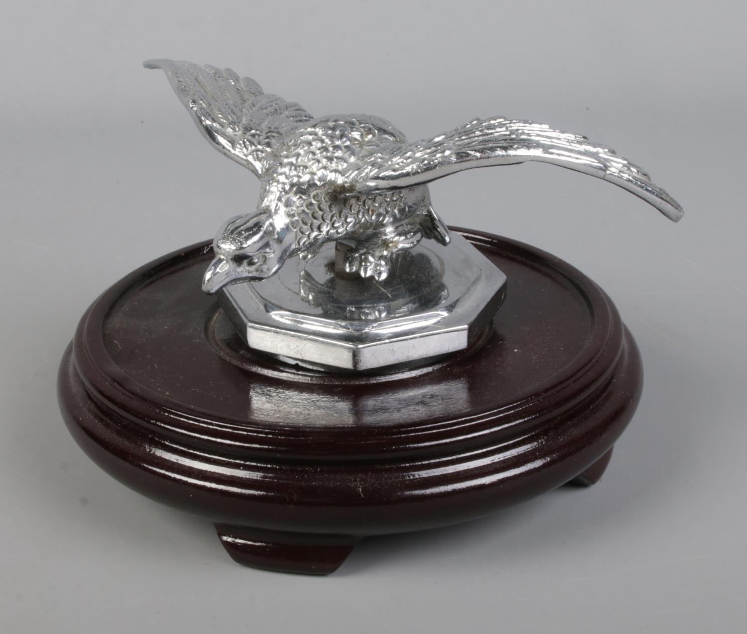 A 1936 MG vintage eagle desmo mascot mounted to hardwood base.