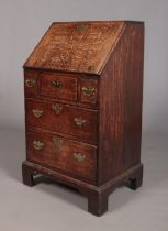 A small oak Georgian bureau. Height 104.5cm, Width 58.5cm, Depth 48cm. Chips to edges of drawers and