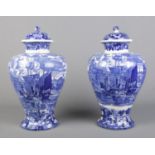 A large pair of late 19th/early 20th century Wedgwood blue and white lidded vases decorated in the