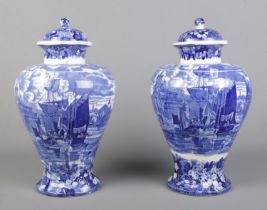 A large pair of late 19th/early 20th century Wedgwood blue and white lidded vases decorated in the