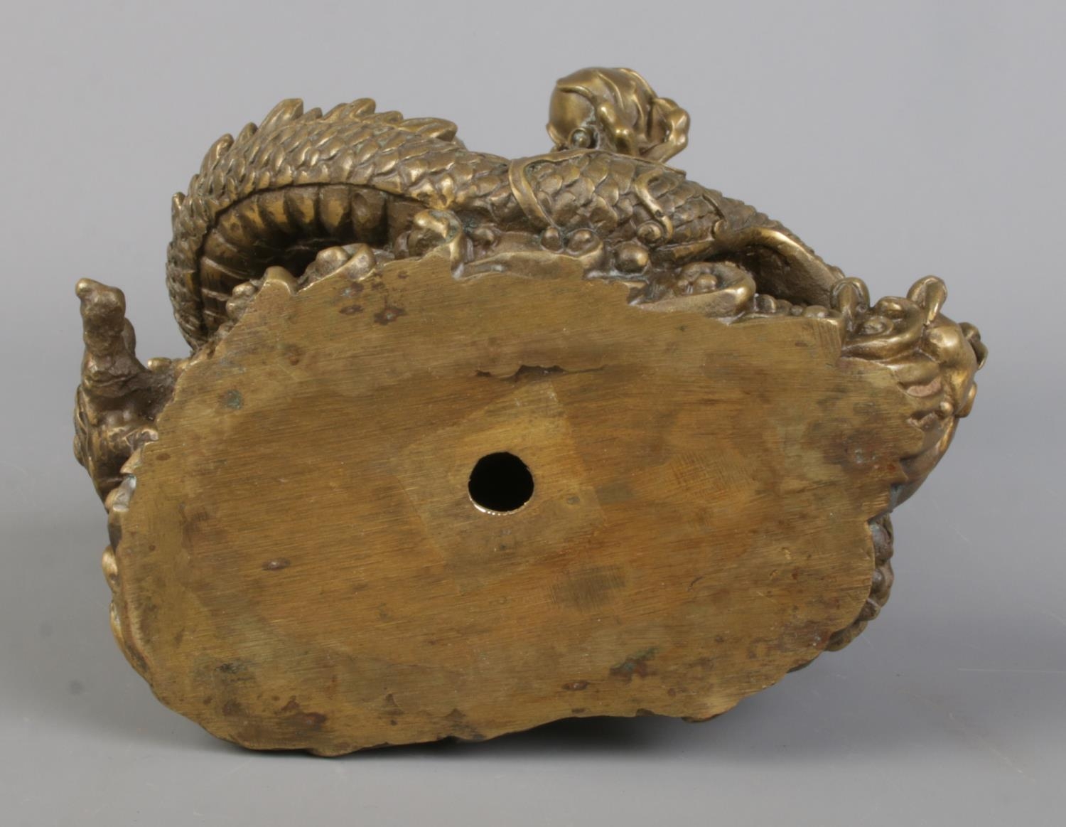 A cast bronze sculpture of a Chinese dragon holding a flaming pearl. Height 18cm. - Image 5 of 5