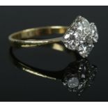 An 18ct gold and four stone diamond ring. The diamonds being round brilliant cut (approximately