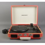 A Crosley portable record player. Model No. CR8005A-OR Requires 9 volt transformer and shell is