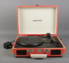 A Crosley portable record player. Model No. CR8005A-OR Requires 9 volt transformer and shell is