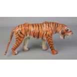 A vintage leather wrapped tiger. Length 38cm