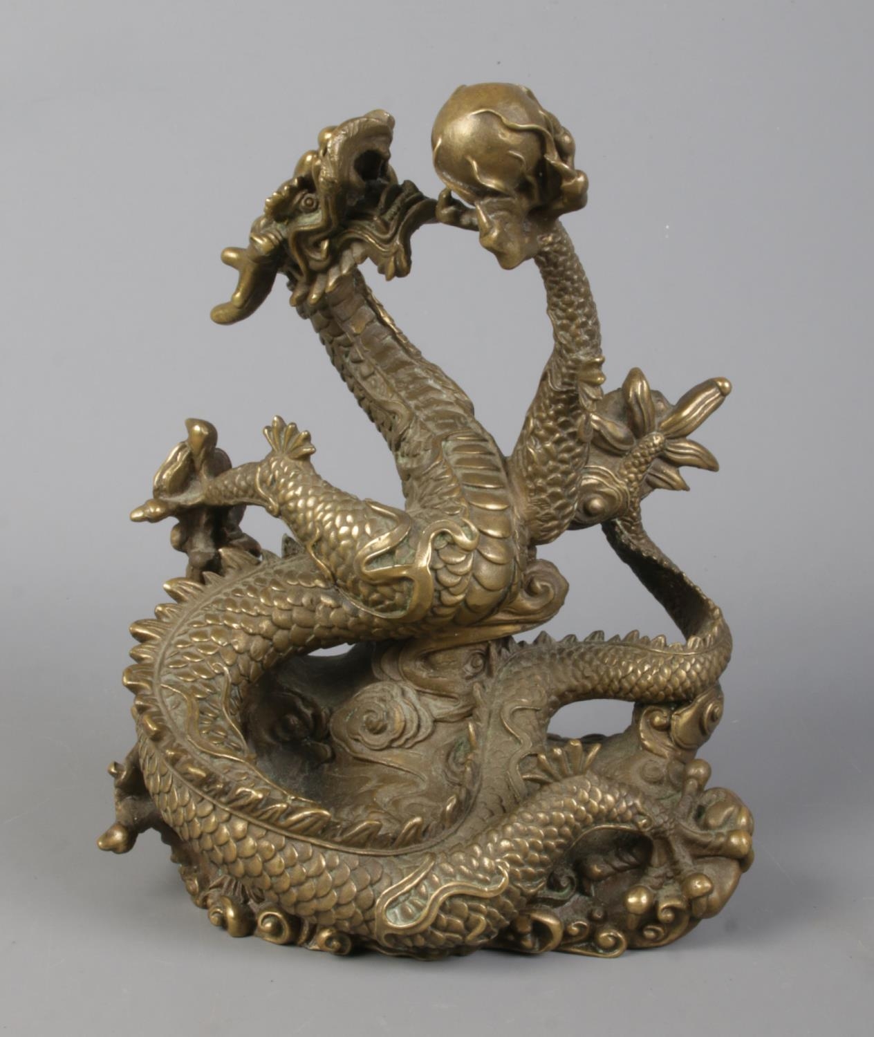 A cast bronze sculpture of a Chinese dragon holding a flaming pearl. Height 18cm. - Image 2 of 5