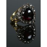 A gold dress ring of heart shape, with central cabochon garnet and diamond surround. Size N 1/2. 4.