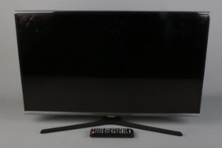 A Samsung 32" flat screen television with remote.