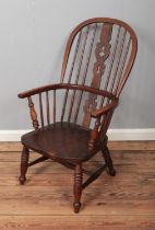 A 19th century ash/elm windsor arm chair with pierced back decoration.