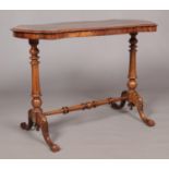 A Victorian burr walnut centre table. With quarter veneered top and raised on turned and carved