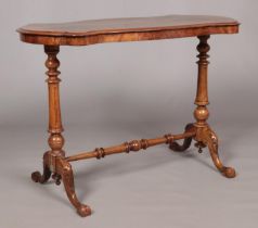 A Victorian burr walnut centre table. With quarter veneered top and raised on turned and carved