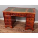 Mahogany twin pedestal desk with green inset leather writing surface. Hx76cm Wx122cm Dx71cm