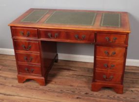 Mahogany twin pedestal desk with green inset leather writing surface. Hx76cm Wx122cm Dx71cm