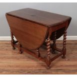 An oak drop leaf table with gate leg base Hx73cm Wx107cm Dx55 Extended 151x107cm