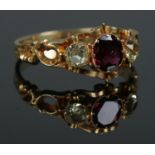 An early to mid 19th century 18ct gold garnet and chrysoberyl three stone ring. Size R. 2.51g.