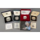 Four cased commemorative Royal Mint silver coins. Includes The Queen Mother Memorial Crown, Marriage